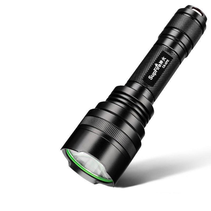Black rechargeable LED flashlight with knurled grip and green ring around lens angled on white background