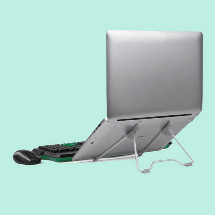 Adjustable laptop stand in use with silver laptop, black keyboard, and wireless mouse on light green background